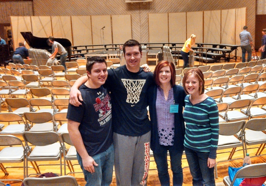 A TRIO OF Mountain Lake Public High School juniors, all members of the Senior Choir, recently attended the Dorian Vocal Festival. Above, standing at the top of the rehearsal and mass choir seating area are, from left, Caleb Rempel, Ben Grev, Vocal Director Andrea Brinkman and Jenny Wright.