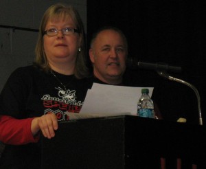 DAWN JOHNSON, HIGH school English teacher, left, was the Bee's prounouncer, while Barry Schmidt, school principal, right, presented awards to the spellers.