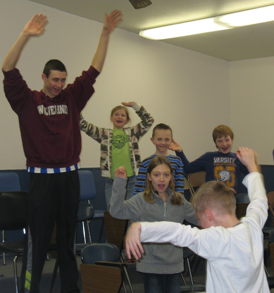 WARM-UP EXERCISES are important before a basketball game - and before music class. Mountain Lake Christian senior Cody Klassen follows the leader in singing preparation in Aaron Petersen's music class.