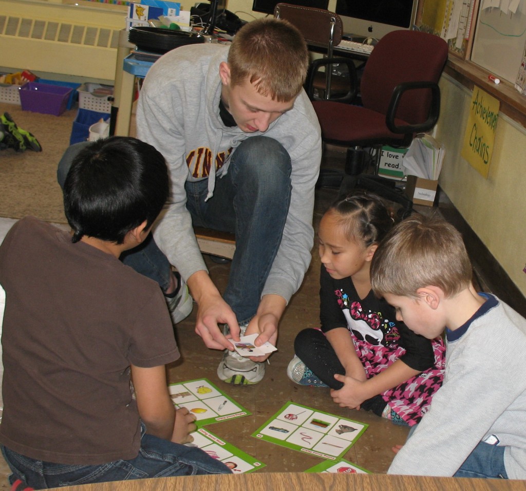 THIS READING GROUP in Kim Blomgren's first-grade classroom at Mountain Lake Public Elementary is being led by senior Joshua Fast.