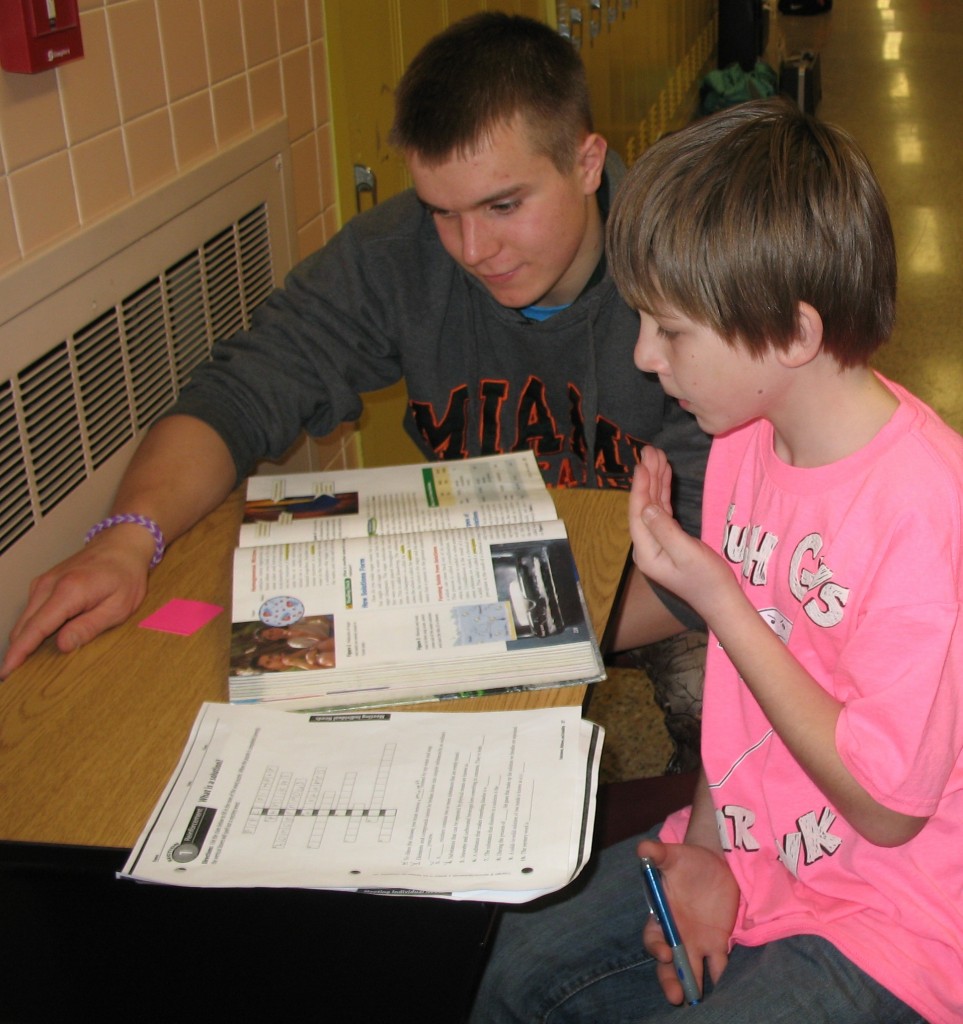 THERE WAS CHEMISTRY - really, they were studying chemistry- between junior Logan Johnson and this sixth-grade student in Annette Kunkel's Mountain Lake Public Elementary classroom.