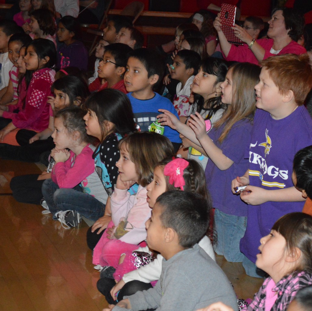 ELEMENTARY STUDENTS CHEER for their favorite "Battle of the Bands" presenters.