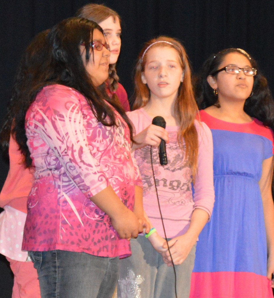 THE QUARTET OF, from left, Andrea Cornejo (behind), Kayla Torres, Susan Fast, Destyne Forstrom and Vanessa Rodriguez vocally harmonize on "Neon Lights."