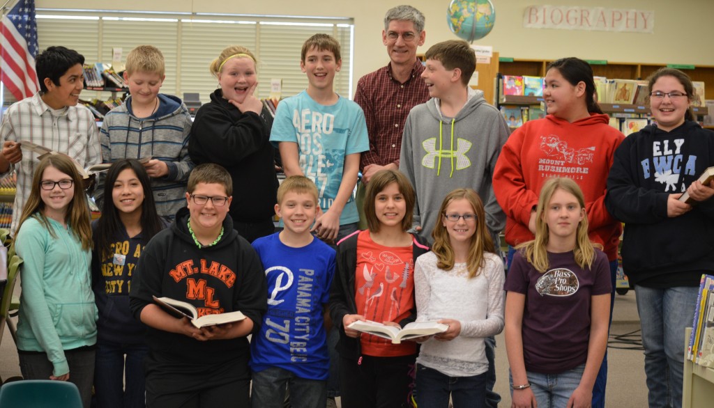 KNOWLEDGE BOWL COMPETITION - called "K-Bowl" to those familiar with the contest - has come to Mountain Lake Public Elementary School (MLES). Jon Harder, Mountain Lake Public School Technology Coordinator, and a coach for both the 7-8 and 9-12 K-Bowl teams, has been working with students in grades five and six, laying down prep work for next fall's meets, coordinated through Southwest/West Central Service Cooperative. This year's sixth-grade participants will move on to the junior high team, while the fifth-graders will move up to be leaders for the elementary unit. An overview meeting was held Wednesday, April 9, as a means of recruiting this year's fourth-graders into participating next fall. K-Bowl competitions include a written round and four oral rounds. Questions test the students' recall, problem-solving and critical thinking skills. Questions asked are inter-disciplinary on an elementary level, and include American history, world history, government, current events, economics and law, geography, literature, English, mathematics, physical science, life science, earth science, health and psychology, art and music and general knowledge of Minnesota. During the contest's oral rounds, teams race against each other to be the first to "buzz in" and answer the question correctly. Above, Coach Jon Harder, center back, is surrounded by his energetic team members. Front, from left, Megan McCue, Jasmine Vongsy, Isaac Grev, Brett Willaby, Sabrina Hanson, Carla Osland and Hana Bergling. Back, from left, Alex Hernandez, Paxton Morin, Saige Wall, John Paulson, Coach Harder, Fletcher Hanson, Emilee Xayanourom and Delainey Janzen. 