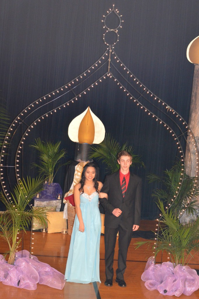 CHUNTANA SAYAVONG, LEFT and her date, Julian Jung, right, enter from backstage and pass through the Grand March route.