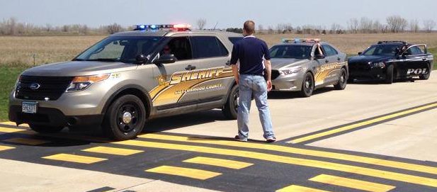 THE LANDING STRIPS at Windom Airport were busy today, Monday, May 5, but not due to incoming and outgoing flights. Rather, local law enforcement entities including the Mountain Lake Police Department, Cottonwood County Sheriff's Office, Jackson County Sheriff's Office and Windom Police Department used the location to train in emergency vehicle operations. Above, Cottonwood County Sheriff Jason Purrington organizes two Cottonwood County Sheriff vehicles, and the Dodge Charger of the Mountain Lake Police, in making their runs.