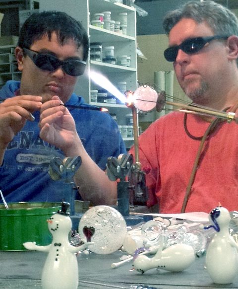 Sam X helping to make a snowman ornament at Glassworks in KY.