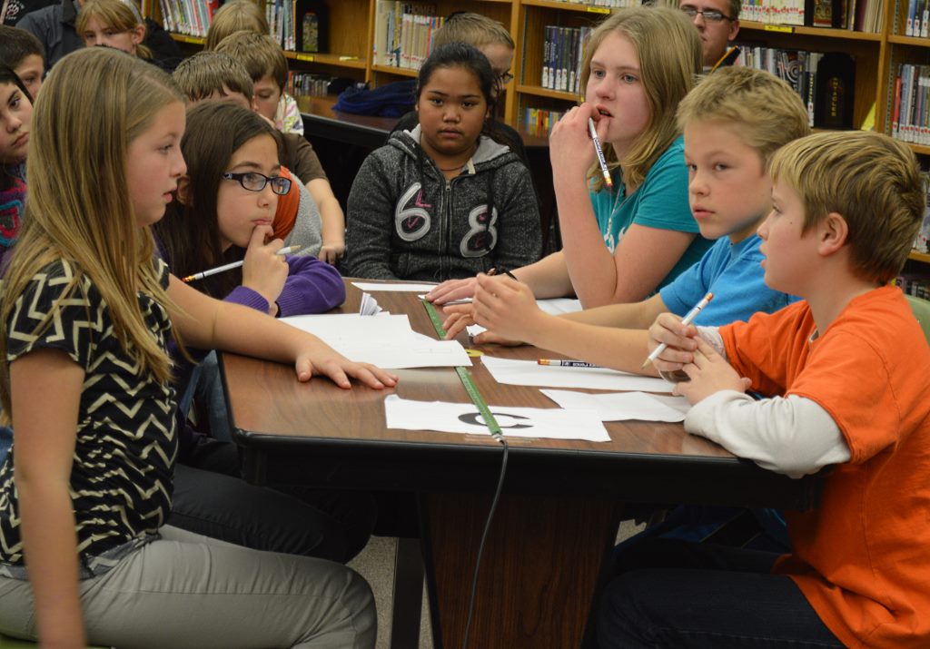 THE FIVE MEMBERS of Team C deliberate over their answer choices. At left, front-to-back, Jasmine Davidson and Olivia Klassen - and, at right, front-to-back, Noah Rempel, Caden Swoboda and Hana Bergling.
