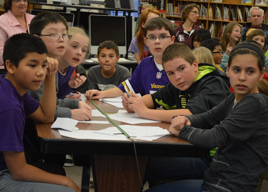 MEMBERS OF TEAM A display intense emotions as they wait for Jon Harder to say if they had correctly answered the question. At left, front-to-back, Jose Garnica, Branden Hopper and Sierra Perkins - and at right, front-to-back, Sabrina Hanson, Kade Wassman and Sam Stade. At back, Landon Boldt observes his friends in competition.