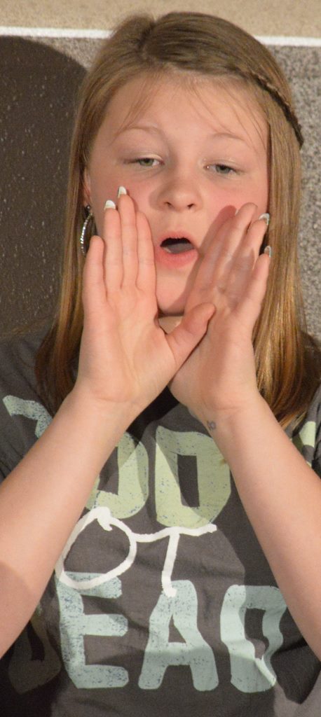 Lord of all the earth. We shout Your name, shout Your name, Filling up the skies With endless praise, endless praise. Yahweh, Yahweh. We love to shout Your name, oh Lord, from the chorus of the selection, "At Your Name (Yahweh, Yahweh). Sixth-grader Zoey Smith is shouting that message.