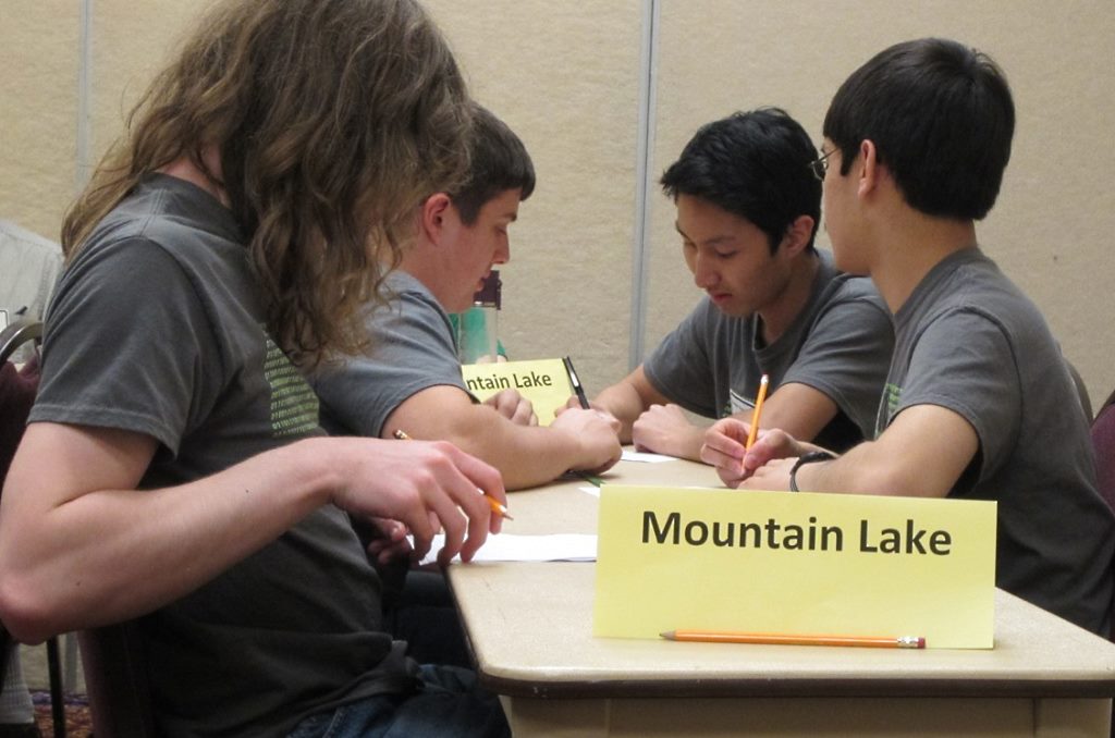 THE MLHS SENIOR High K-Bowl Team in action during one of the five oral rounds at the state contest. From left, Reece Englund, Caleb Rempel, Hamlet Tanyavong and Daniel Harder. (Jon Harder photo)