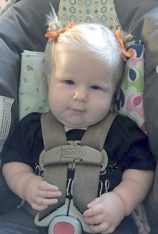 KENDALL MARCY, NOW six months old, looking fine with "piggy" tails.