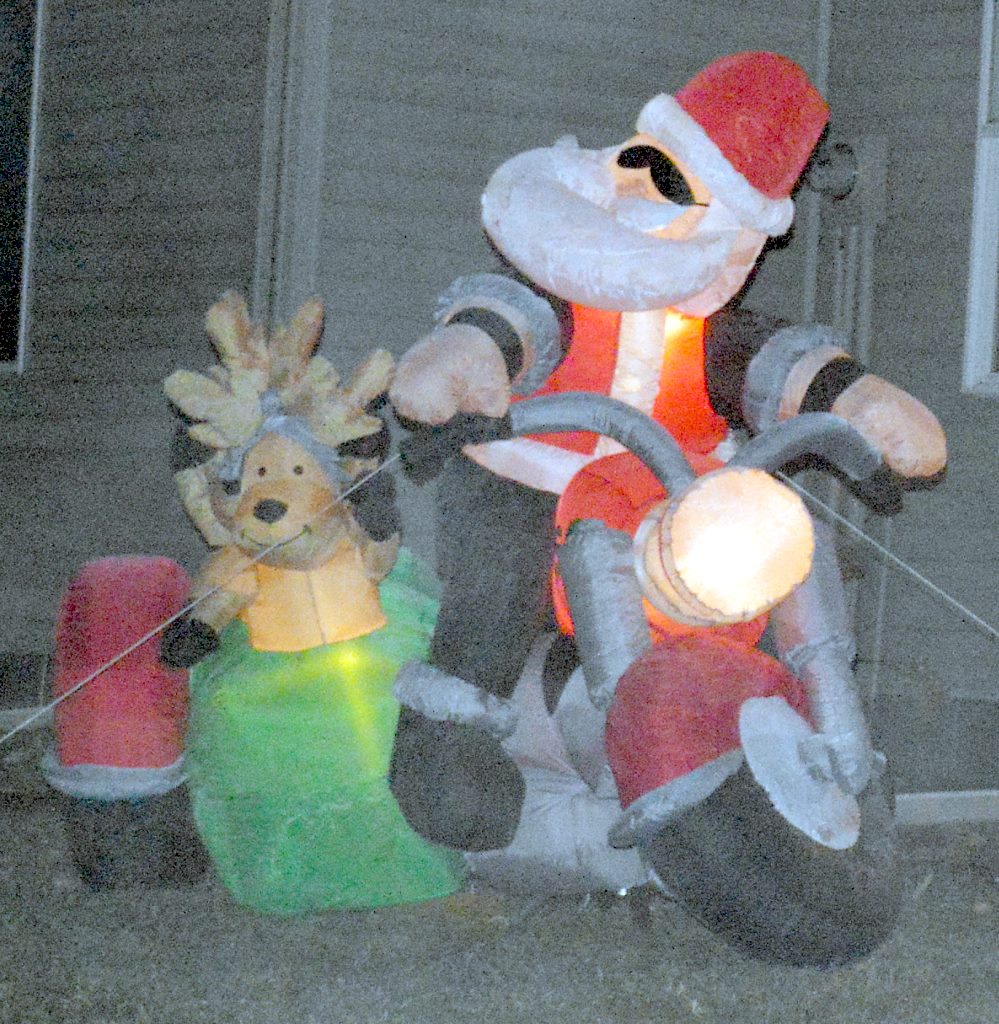 PAT OJA AND Abbey Schultze included biker Santa on his hog, with his a reindeer sidekick sitting in the sidecar in their light display.