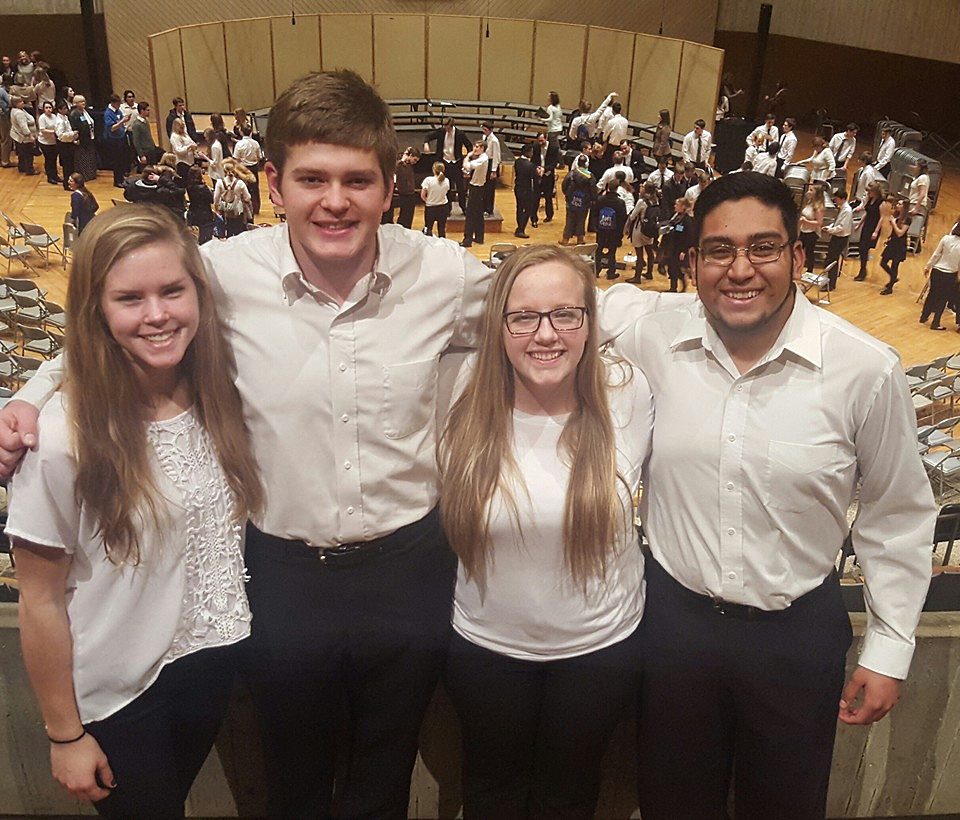 A TRIO OF Mountain Lake Public High School juniors, all members of the Senior Choir, recently attended the Dorian Vocal Festival. Above, standing at the top of the rehearsal and mass choir seating area are, from left, Caleb Rempel, Ben Grev, Vocal Director Andrea Brinkman and Jenny Wright.