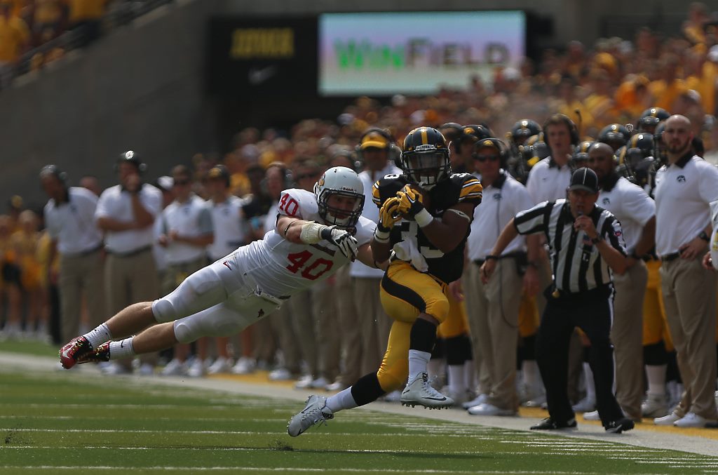 Iowa running back Jordan Canzeri attempts to avoid Illinois State linebacker Alex Donnelly during the Iowa-Illinois State game in Kinnick on Saturday, Sept. 5, 2015. The Hawkeyes defeated the Redbirds, 31-14. (The Daily Iowan/Margaret Kispert)