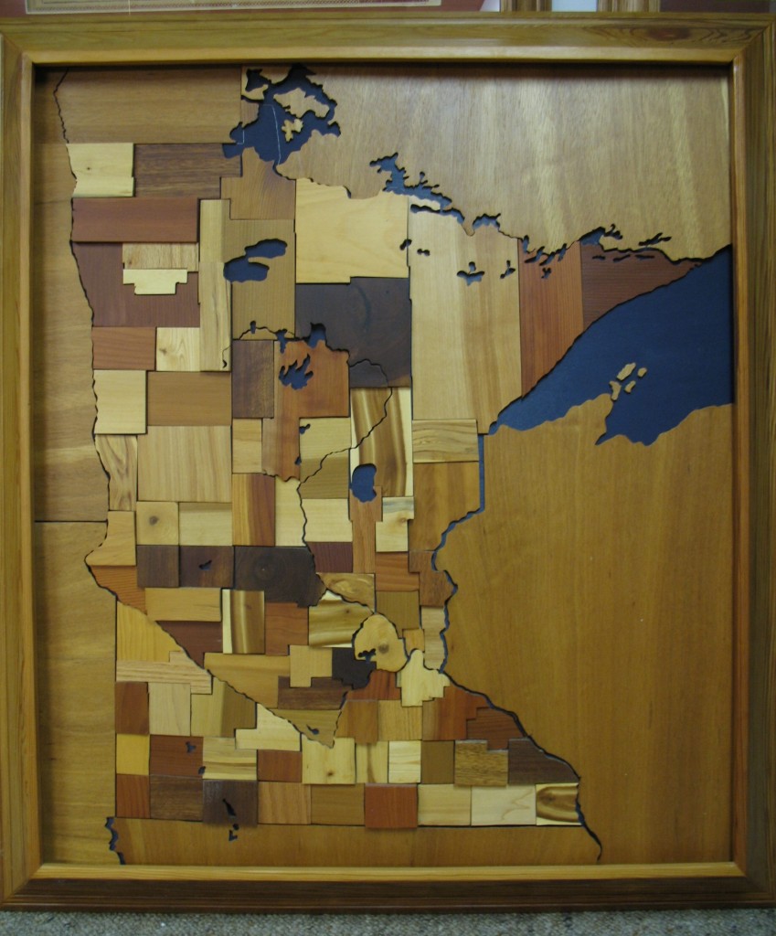 WOODEN MAP OF Minnesota featuring a variety of different woods and made by Lester Rupp of Mountain Lake, Minnesota.