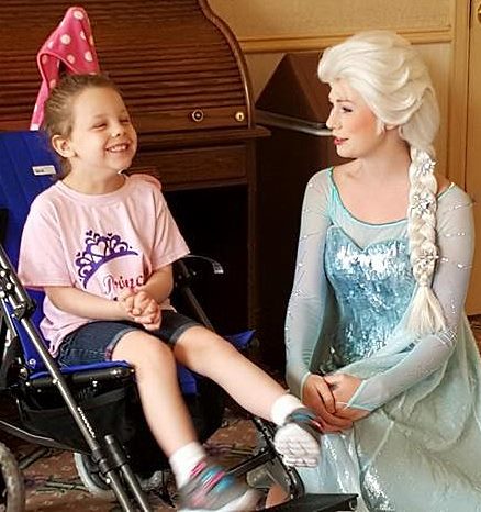 ADDYSON JANZEN, RIGHT, was thrilled to her toes - clearly demonstrated by her ear-to-ear grin - to be able to meet Princess Elsa, right, while recently visiting Disney World in Florida. (Photo courtesy of Kimberly Janzen)